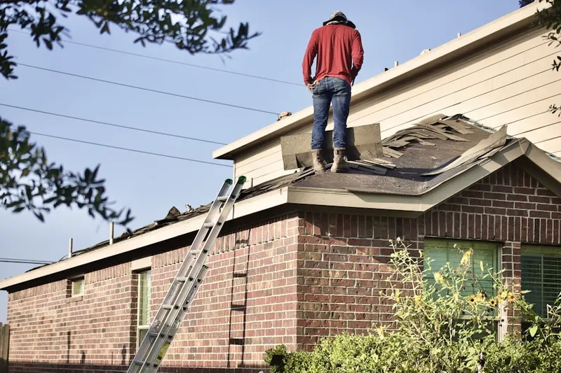 Professional roofer working on a residential roof in Academyville